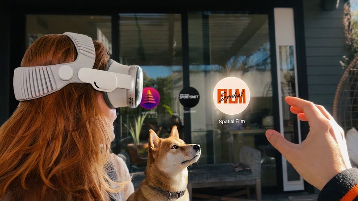 A viewer wearing Apple Vision Pro reaches toward a floating Spatial Film app icon, with a Shiba Inu sitting beside her