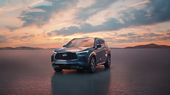 An elegant INFINITI QX60 luxury SUV parked against a scenic backdrop. The sleek design and polished exterior showcase the modern aesthetic of this stylish vehicle.